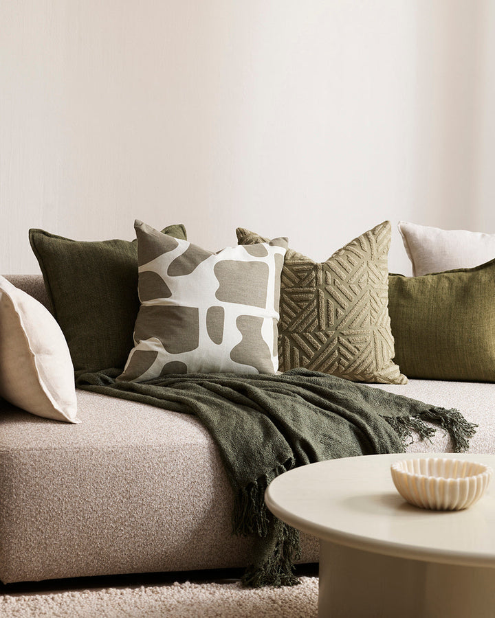 Remus Cushion Tufted embroidery on a natural base forms the texture on this relaxed and expressive cushion. Centred on a serene colour palette of ecru and taupe, the subtly tribal surface design looks great paired with finely woven linens in neutral and c