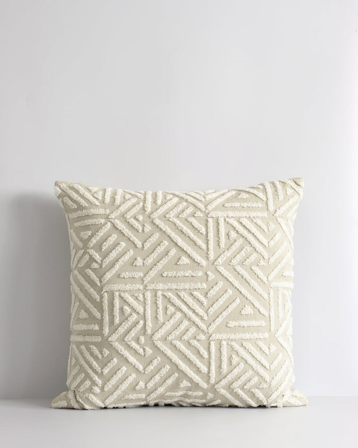 Remus Cushion Tufted embroidery on a natural base forms the texture on this relaxed and expressive cushion. Centred on a serene colour palette of ecru and taupe, the subtly tribal surface design looks great paired with finely woven linens in neutral and c