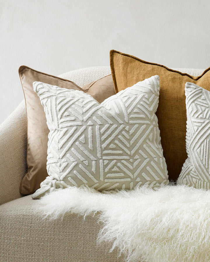 Remus Cushion Tufted embroidery on a natural base forms the texture on this relaxed and expressive cushion. Centred on a serene colour palette of ecru and taupe, the subtly tribal surface design looks great paired with finely woven linens in neutral and c