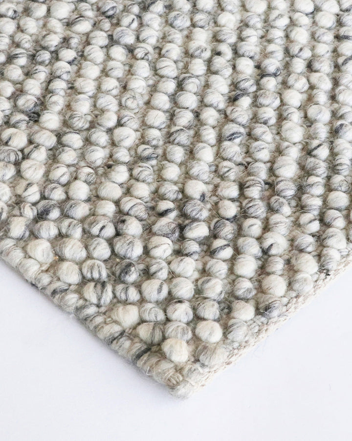 Roxburgh Floor Rug Bring a stylish and sophisticated feel to your space with the textured beauty of our Roxburgh floor rug. Carefully handmade, wool blend fibres are woven into tight bobbles, showcasing the fibreâ€™s tonal blends. An easy addition for any