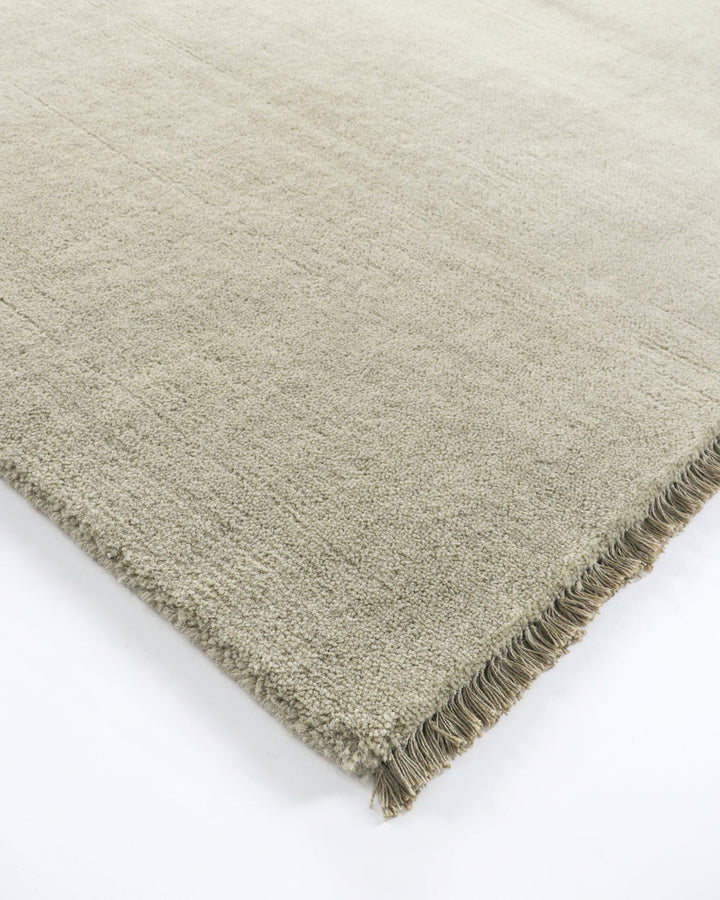 Sandringham Floor Rug Create a sophisticated sanctuary with the dense, sumptuous pile of the Sandringham. Soft and supportive underfoot, this floor rug is handknotted from 100% wool, featuring a cut pile and delicate fringing at both ends. The neutral fog