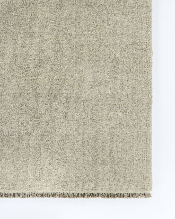 Sandringham Floor Rug Create a sophisticated sanctuary with the dense, sumptuous pile of the Sandringham. Soft and supportive underfoot, this floor rug is handknotted from 100% wool, featuring a cut pile and delicate fringing at both ends. The neutral fog