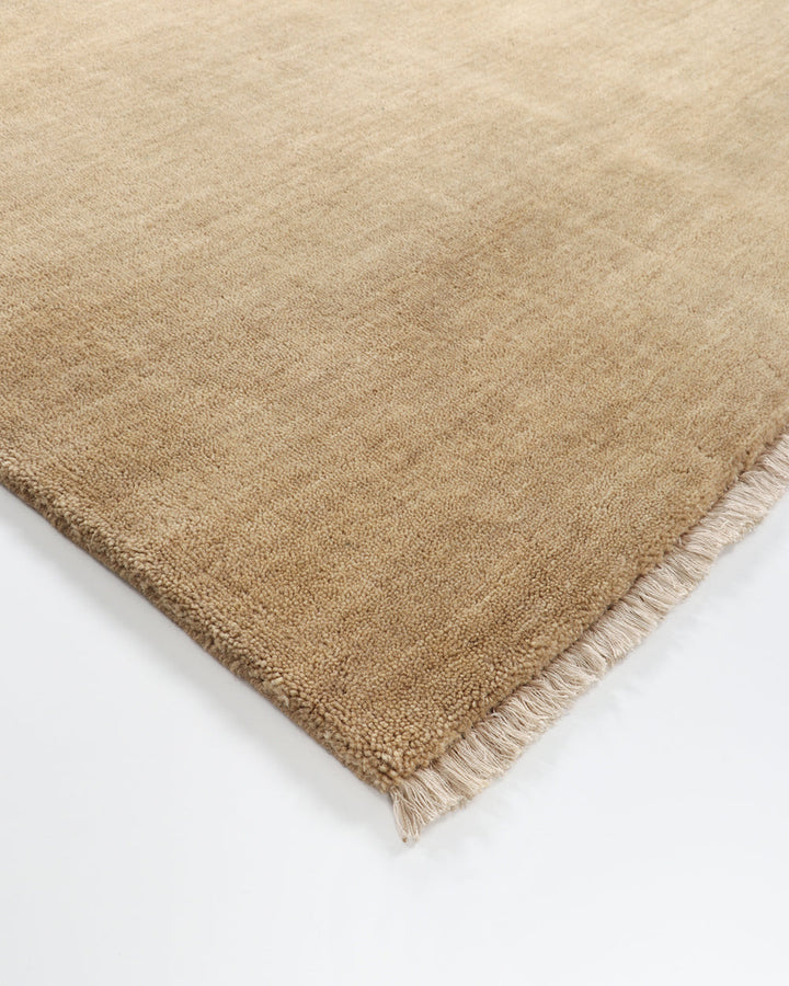 Sandringham Floor Rug Create a sophisticated sanctuary with the dense, sumptuous pile of the Sandringham. Soft and supportive underfoot, this floor rug is handknotted from 100% wool, featuring a cut pile and delicate fringing at both ends. The neutral fog