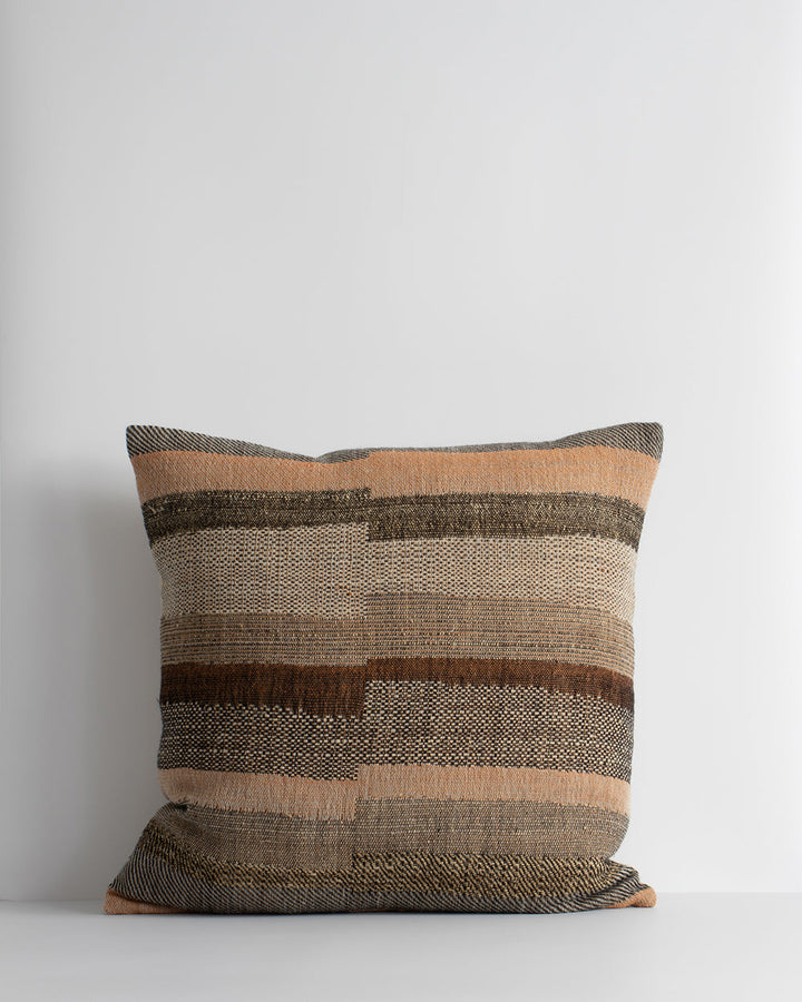 Saratoga Cushion Constructed from sections of artisanal woven fabric, the Saratoga is handwoven using a stunning blend of wild tussar silk and fine wool. Celebrating natural fibres, the earth and subtle peach tones create a globally inspired, artisan aest