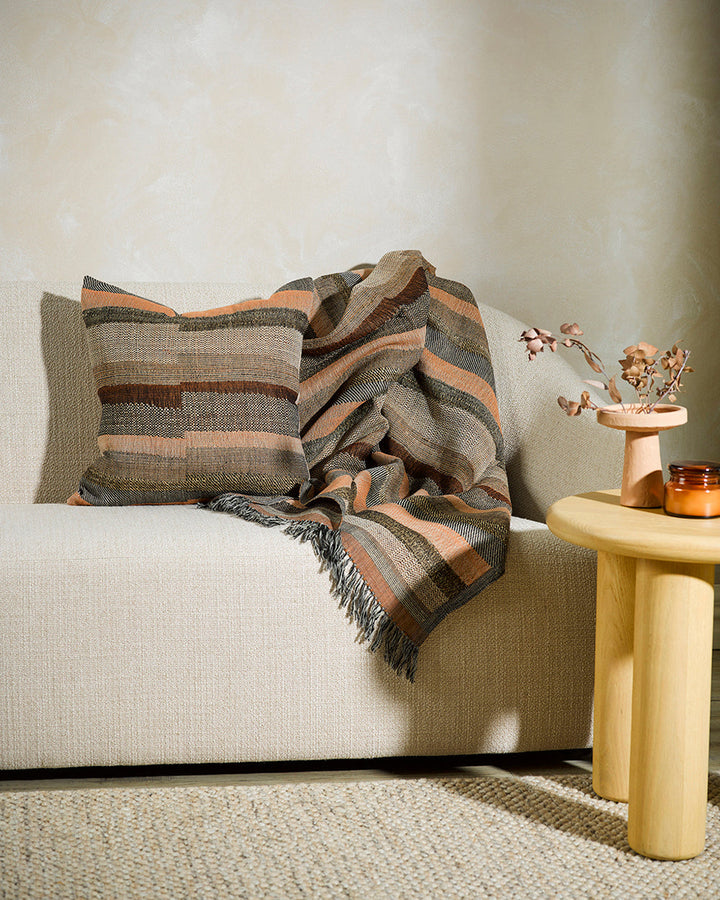 Saratoga Cushion Constructed from sections of artisanal woven fabric, the Saratoga is handwoven using a stunning blend of wild tussar silk and fine wool. Celebrating natural fibres, the earth and subtle peach tones create a globally inspired, artisan aest