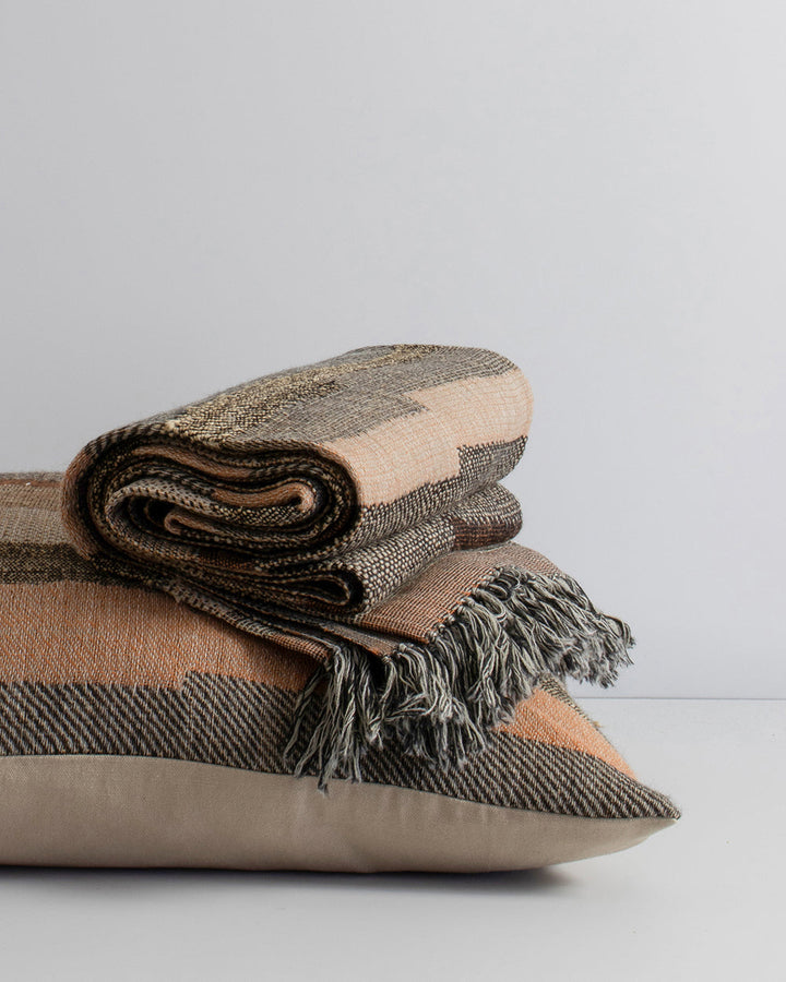 Saratoga Cushion Constructed from sections of artisanal woven fabric, the Saratoga is handwoven using a stunning blend of wild tussar silk and fine wool. Celebrating natural fibres, the earth and subtle peach tones create a globally inspired, artisan aest