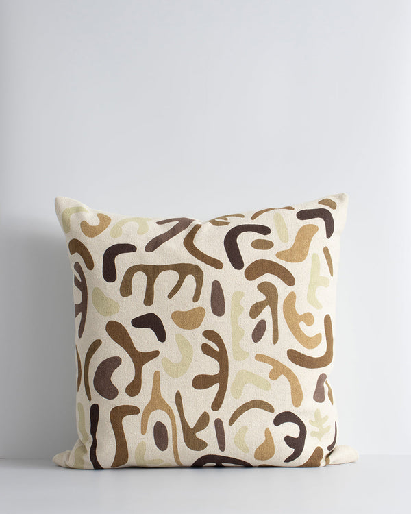 Silhouette Cushion Hand-cut forms are assembled in cocoa, biscuit, and ecru shades on this Matisse-inspired cushion. Printed onto a 100% cotton base, the warm tones and playful nature of this piece creates a comforting and cosy aesthetic. Pair with Sabina