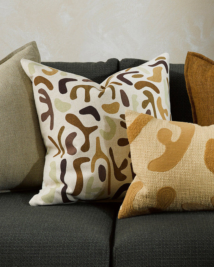 Silhouette Cushion Hand-cut forms are assembled in cocoa, biscuit, and ecru shades on this Matisse-inspired cushion. Printed onto a 100% cotton base, the warm tones and playful nature of this piece creates a comforting and cosy aesthetic. Pair with Sabina