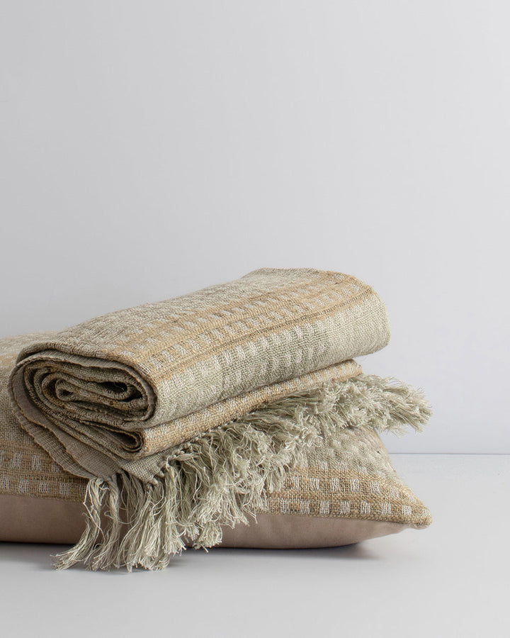 Solano Cushion Celebrating the beauty of artisanal woven fabric, Solano is an exquisite textural piece in shades of muted sage, grey and putty. Handwoven in a silk-linen blend, the delicate surface pattern creates an inviting and serene aesthetic. Pair wi