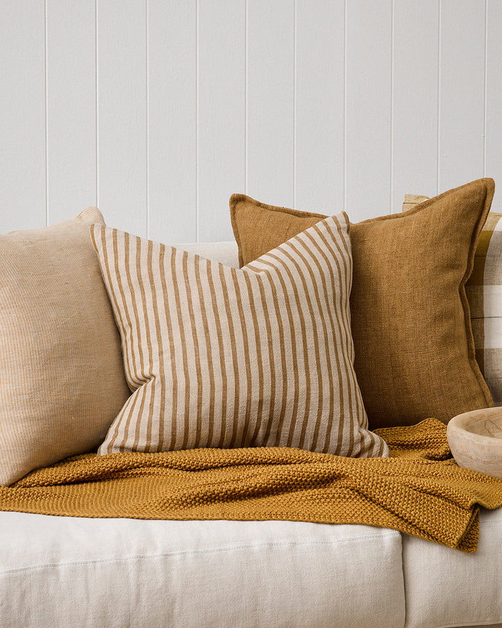 Spencer Cushion The essence of understated elegance is celebrated with the classic Bengal stripe design of the Spencer. Handwoven by skilled artisans, the medium-weight fabric embracesÂ the natural beauty of linen fibres, instilling an earthy, organic fee