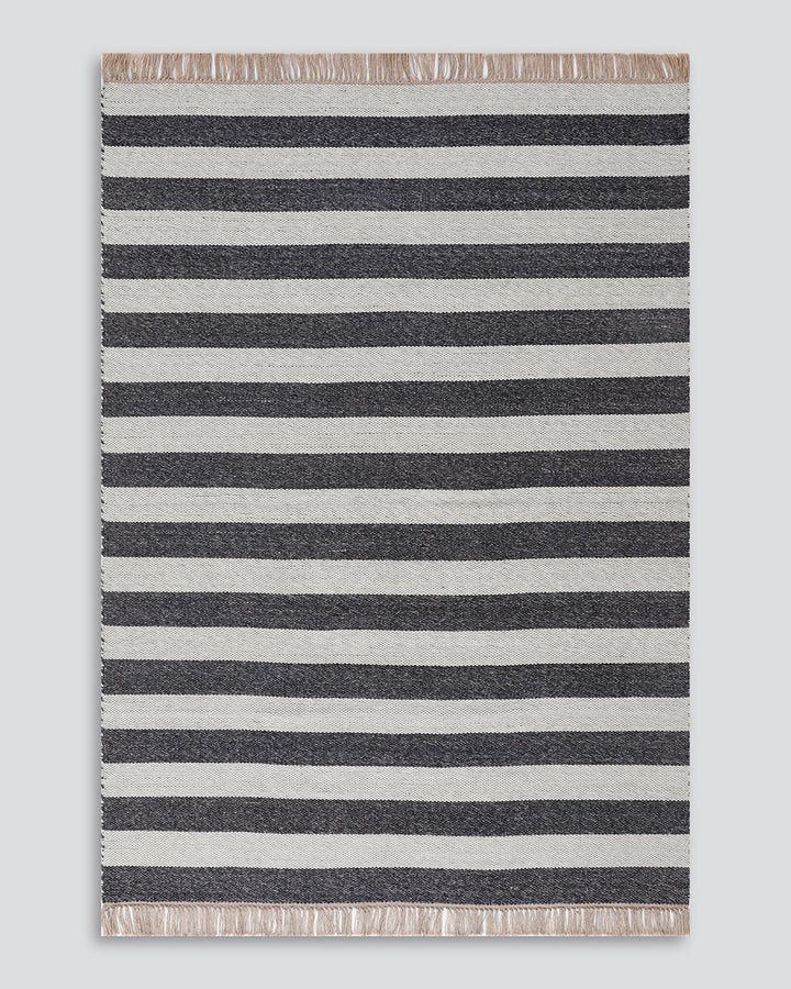 Summit Floor Rug A contemporary and fully reversible outdoor rug. The handcrafted double-weave stripe design looks stunning on any surface and can be used indoors and outdoors interchangeably. Featuring a heavy stripe on one side, and a finer design on th