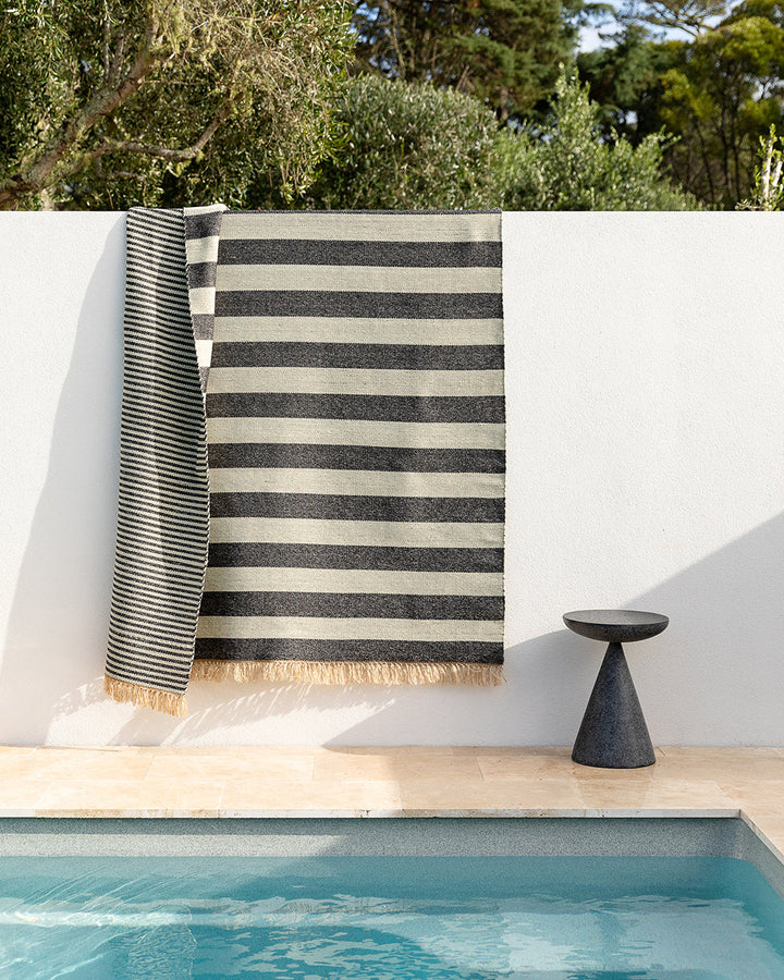 Summit Floor Rug A contemporary and fully reversible outdoor rug. The handcrafted double-weave stripe design looks stunning on any surface and can be used indoors and outdoors interchangeably. Featuring a heavy stripe on one side, and a finer design on th