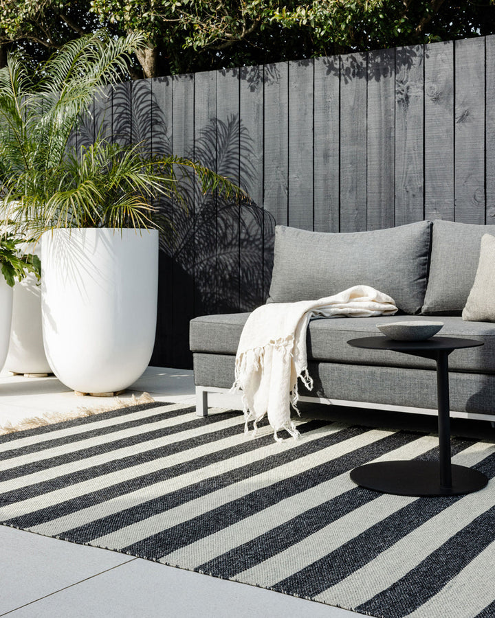 Summit Floor Rug A contemporary and fully reversible outdoor rug. The handcrafted double-weave stripe design looks stunning on any surface and can be used indoors and outdoors interchangeably. Featuring a heavy stripe on one side, and a finer design on th