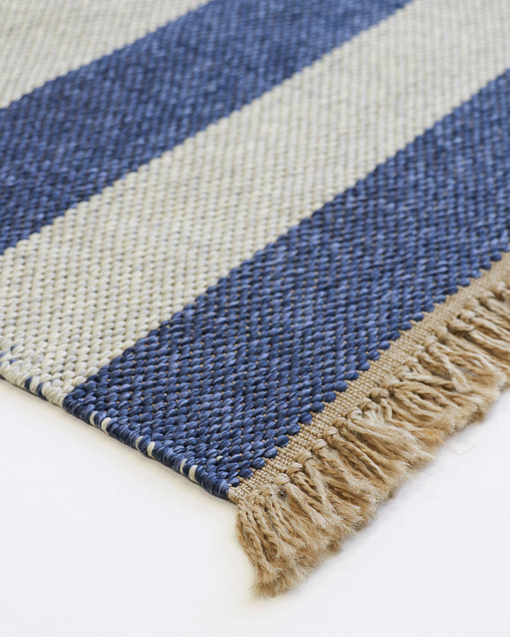 Summit Floor Rug A contemporary and fully reversible outdoor rug. The handcrafted double-weave stripe design looks stunning on any surface and can be used indoors and outdoors interchangeably. Featuring a heavy stripe on one side, and a finer design on th