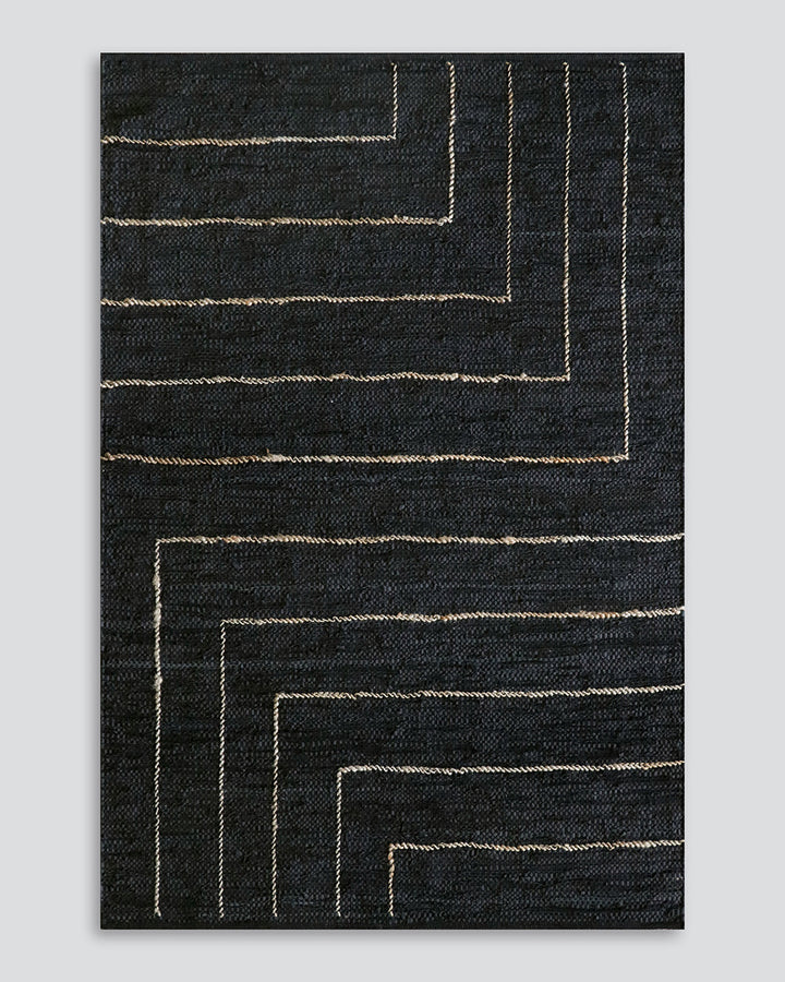 Tunja Floor Rug Ideal for laid-back living spaces, the soft black leather and embroidered jute design of the Tunja makes for a simple and relaxed aesthetic. Pair with handmade objects and textiles for a raw and rustic interior look. Australian Stock Buy a