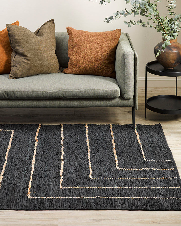 Tunja Floor Rug Ideal for laid-back living spaces, the soft black leather and embroidered jute design of the Tunja makes for a simple and relaxed aesthetic. Pair with handmade objects and textiles for a raw and rustic interior look. Australian Stock Buy a