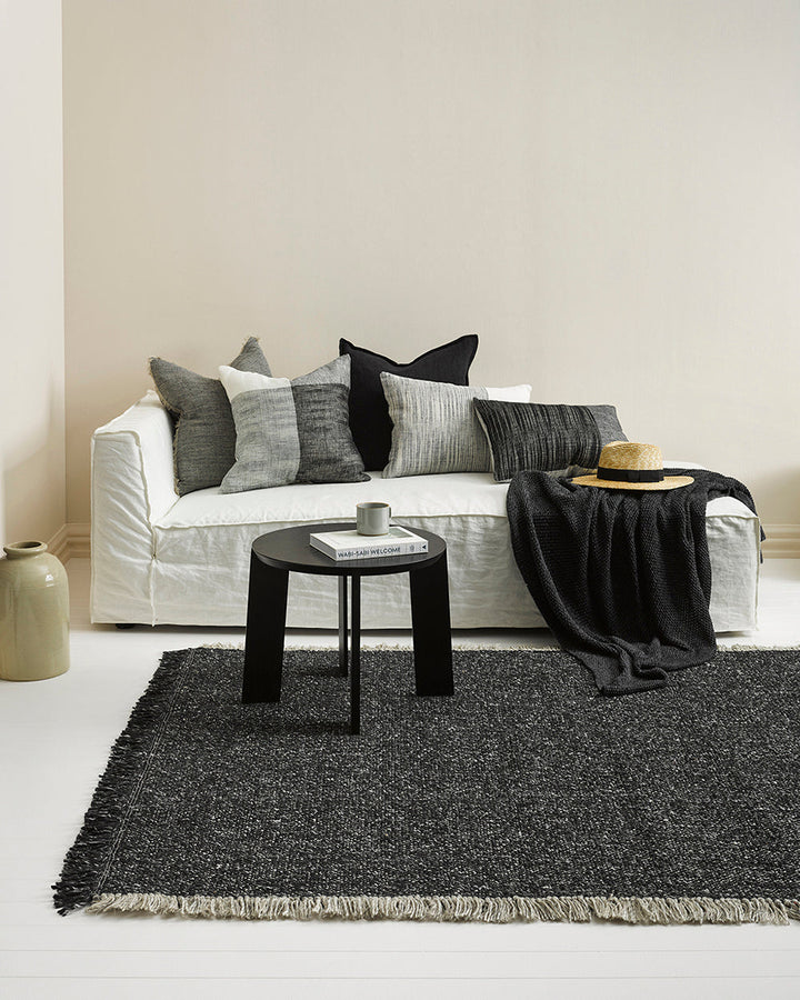 Ulster Floor Rug Create a casual yet refined interior with the subtle texture of the Ulster. Wool and linen fibres are handwoven in a classic 1-1 structure, which are blended in a contemporary monochrome colourway. Two-tone fringing finishes the design, s