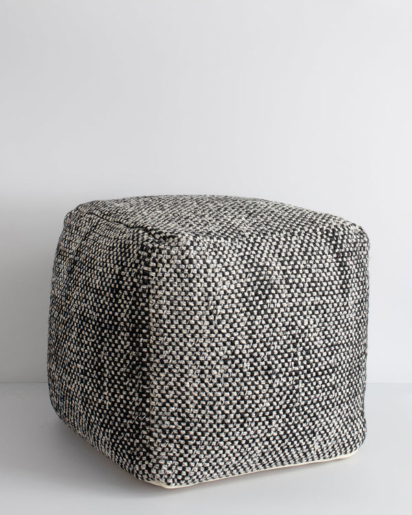 Ulster Black/Natural Ottoman Bring an element of comfort and texture to your space with our handwoven Ulster ottoman. Wool and linen fibres are handwoven in a classic 1-1 structure, which are blended for a rustic yet refined look â€“ the perfect finishing