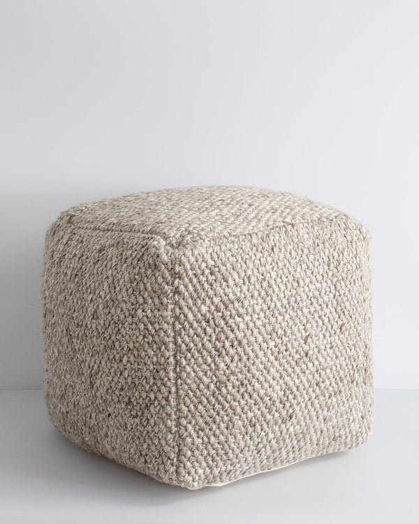 Ulster Taupe Ottoman Bring an element of comfort and texture to your space with our handwoven Ulster ottoman. Wool and linen fibres are handwoven in a classic 1-1 structure, which are blended for a rustic yet refined look â€“ the perfect finishing piece f