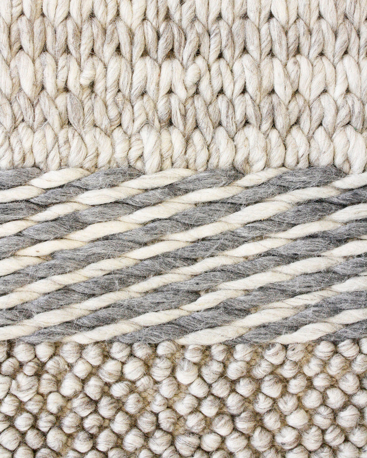 Valley Floor Rug Inspired by dry landscapes and the stony riverbeds of Southland, the Valleyâ€™s design features a range of different weaving techniques in a beautiful wool and cotton blend. Tones of muted blue, ivory and taupe harmonise to create a relax