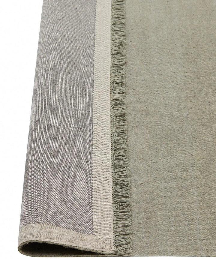 Emilio Flint - Premium Linen Rug for Modern Homes Emilio Flint adds serene sophistication with its grey-blue hue and refined fringe, perfect for contemporary and minimalist spaces.