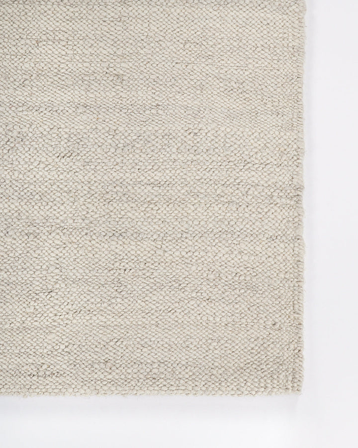 Wichita Floor Rug Add subtle texture to your space with the simplicity of pure wool. Handwoven by skilled artisans, the undyed ecru tone and tight slubby weave construction of the Wichita creates warmth and depth for contemporary living. Australian Stock