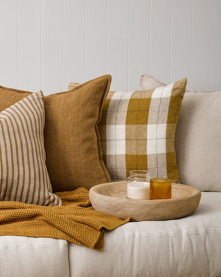 Willis Cushion Country charm is reinterpreted for urban living with Willis â€“ a relaxed, handwoven plaid design. In a modern twist, traditional fabric is re-imagined in a rich tobacco tone that is both elegant and understated. Pair with tones in compleme