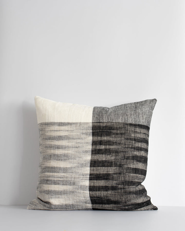 Wilson Cushion Embrace contemporary luxury with the artisan weave of our Wilson cushion. Crafted in a cool monochromatic palette in an off-set plaid, this double-sided design in 100% linen provides a simple, textural aesthetic for a modern living space. P