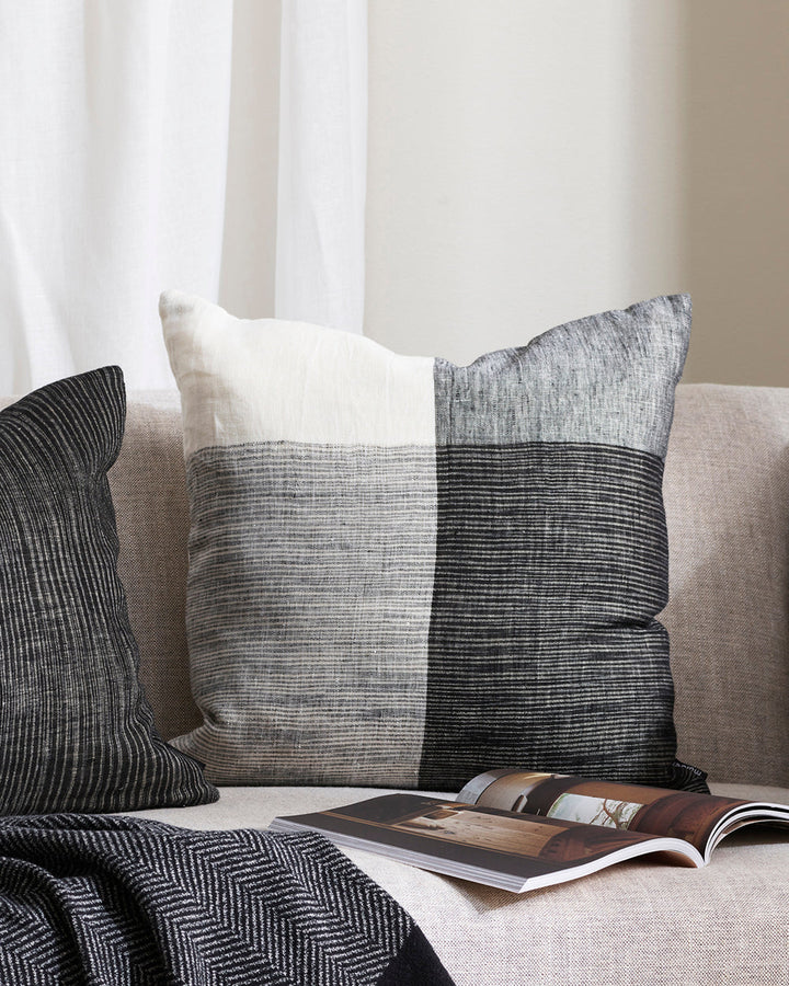 Wilson Cushion Embrace contemporary luxury with the artisan weave of our Wilson cushion. Crafted in a cool monochromatic palette in an off-set plaid, this double-sided design in 100% linen provides a simple, textural aesthetic for a modern living space. P