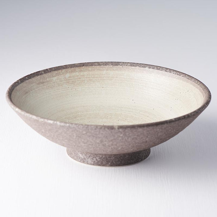 Save on Nin-Rin Ramen Bowl Made in Japan at BEON. 25cm diameter x 8cm height Ramen Bowl in Nin-Rin design The Nin-Rin range features a circular sweep of golden ochre over the signature 'Earth' glaze. No two pieces are the same due to a unique hand glazing technique used to create the swirling pattern. Traditionally used for ramen, this bowl can be used for curries, risottos, salads or pasta. The ramen bowl makes a great engagement or wedding gift. Handcrafted in JapanMicrowave and dishwasher safe