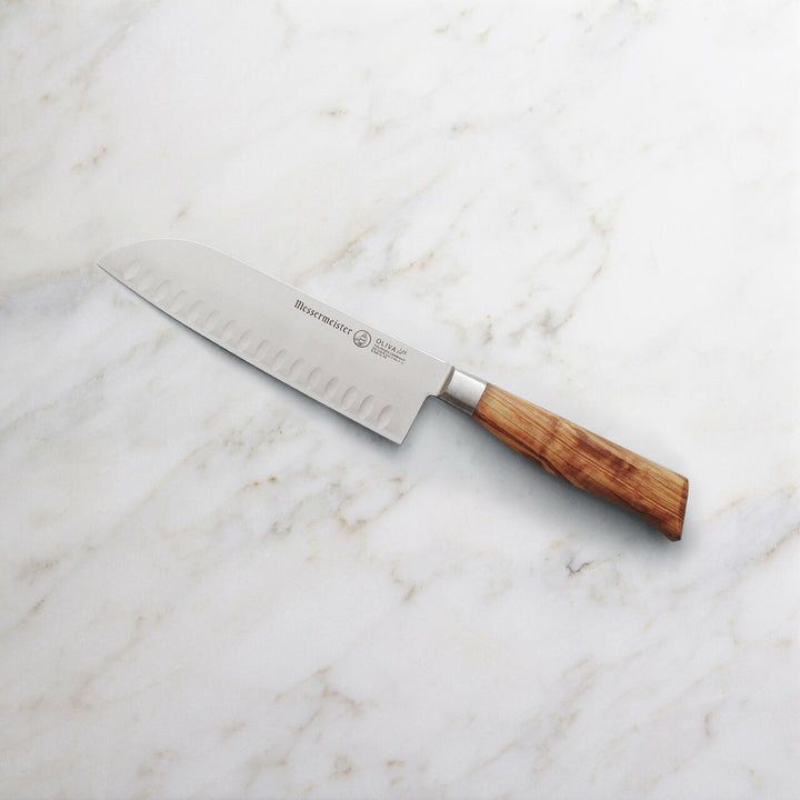 Buy online & save Oliva Elite Kullenschliff Santoku Knife 7 Inch (17.8cm) |Messermeister |BEON.COM.AU E6610 7K      Oliva Elite 7 Inch Kullenschliff Santoku Knife The Messermeister Oliva Elite 7 Inch Kullenschliff Santoku is a versatile Japanese chef’s knife with a thin taper for maximum precision when slicing vegetables, fish and meat. The hollow oval shape of the kullens on either side of the b... Messermeister at BEON.COM.AU