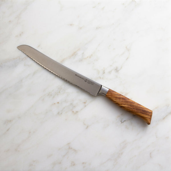 Buy online & save Oliva Elite Scalloped Bread Knife 9 Inch (22.9cm) |Messermeister |BEON.COM.AU E6699 9         Oliva Elite 9 Inch Scalloped Bread Knife The Messermeister Oliva Elite 9 Inch Bread Knife has a scalloped edge with a gentle camber. Serrations on this knife’s scalloped edge produce smooth, clean and precise cuts whether you’re slicing bread or soft-skinned fruits and vegetables.... Messermeister at BEON.COM.AU