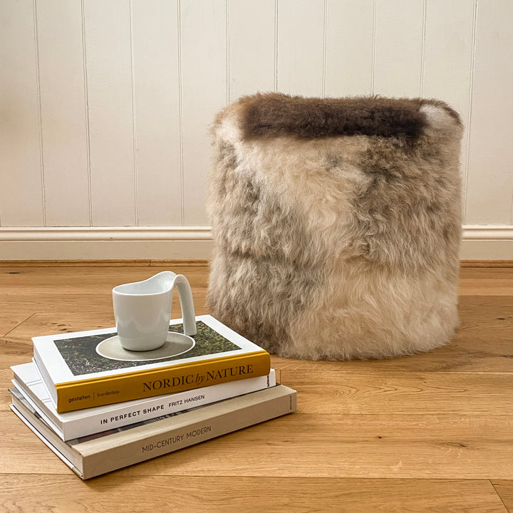 Buy Lhasa Ottoman | Lhasa Ottoman by Fibre at BEON | Himalayan Lhasa Longwool Sheepskin Ottoman with safety zipper, 100% polystyrene bean fill, leather base.