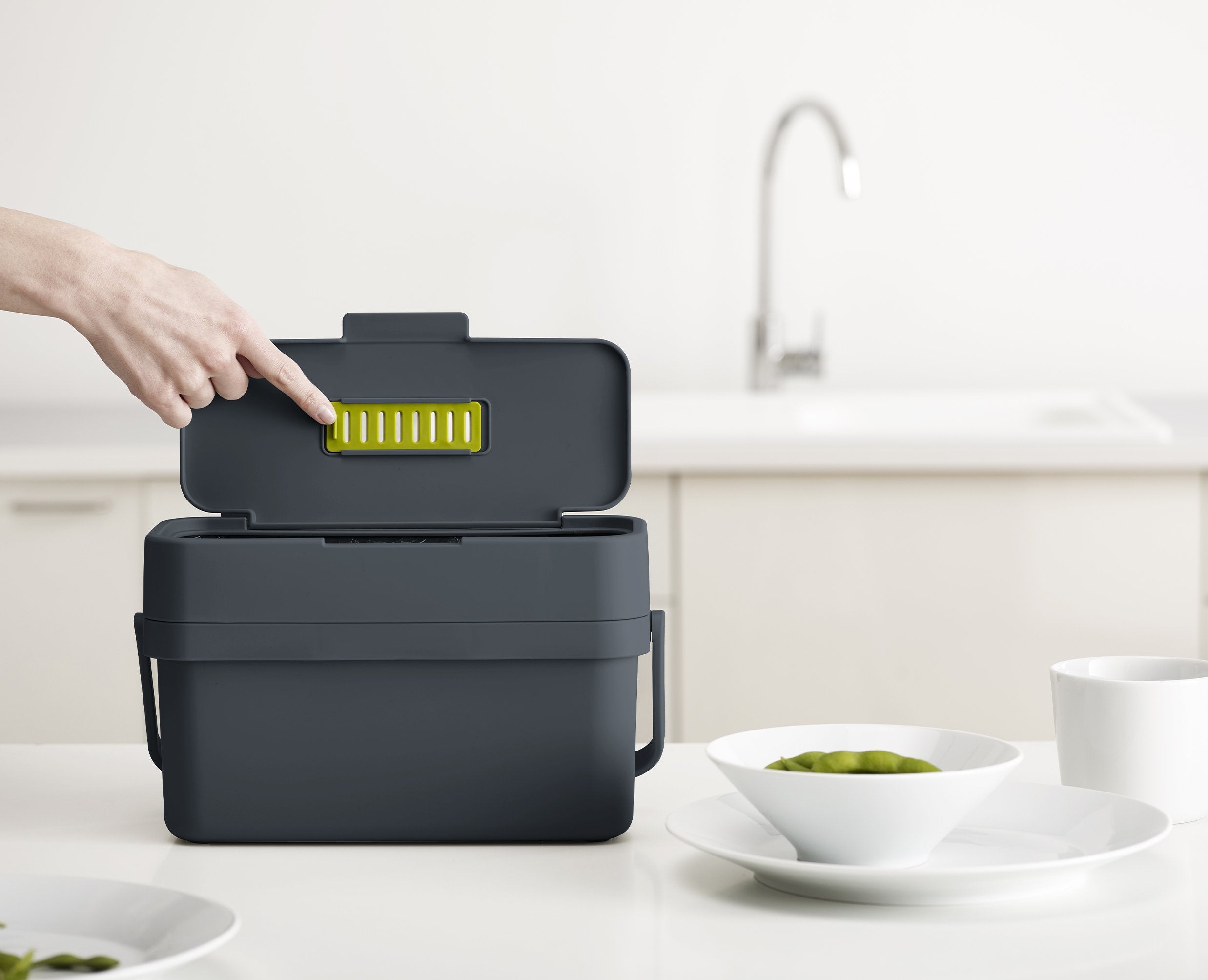BEON.COM.AU  This slimline food waste caddy is designed to make collecting food scraps easier as it features a convenient flip-up lid and extra wide opening.  Wide aperture makes scraping food from plates easier Adjustable air vent: open - helps reduce moisture and odour build-up; closed - provides insect ba... Joseph Joseph at BEON.COM.AU