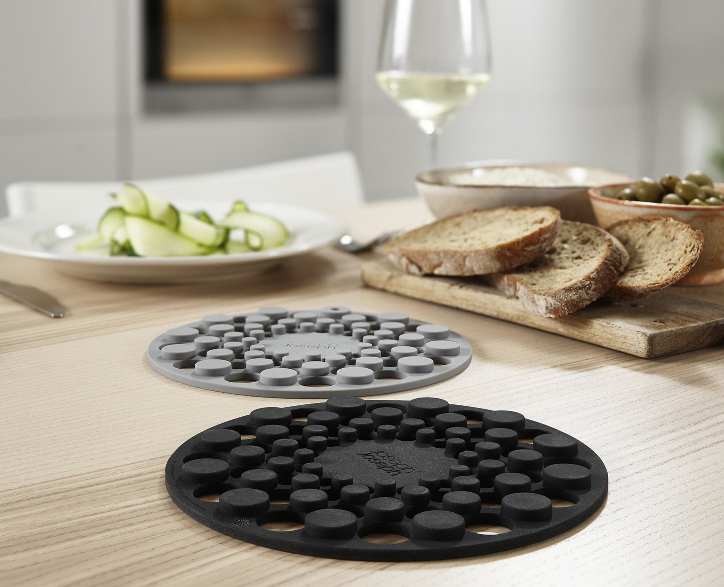 BEON.COM.AU  These two heat and stain-resistant circular trivets fit neatly together for compact storage.  Heat-resistant up to 220˚C (428˚F) Protects surfaces from scratches and heat damage Stain-resistant Store together saving valuable drawer space Easy to clean - dishwasher safe  Specifications  Care &amp... Joseph Joseph at BEON.COM.AU