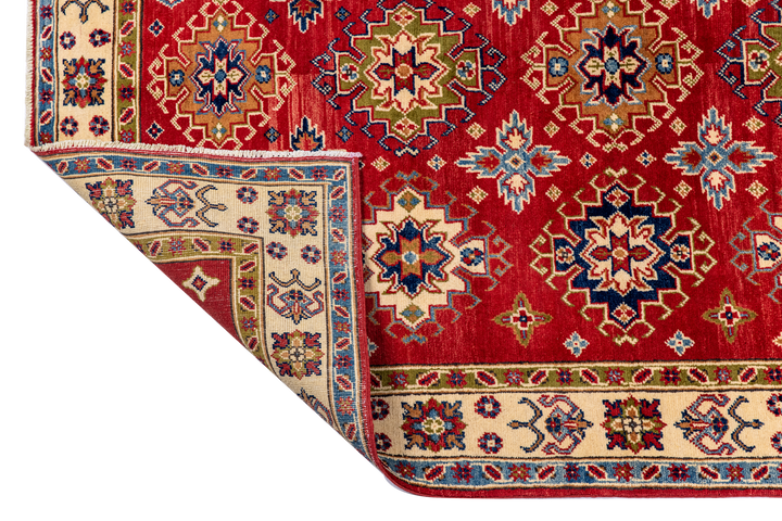 Buy Authentic Fine Afghan Kazak Afghan Rugs made in Afghanistan at BEON | Size: 152x217cmFoundation: CottonPile: Handspun WoolShape: Rectangular Hand knotted and meticulously crafted by Afghan artisans in Afghanistan, this stunning Chobi rug is made out o