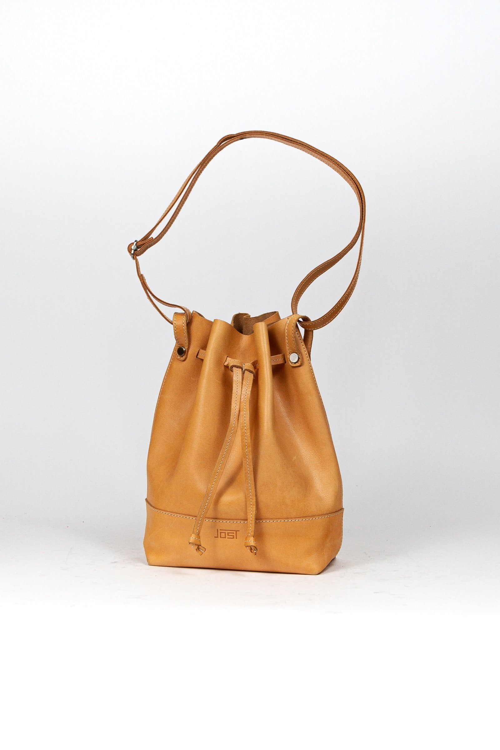BEON.COM.AU The Jost Vantaa Bucket Bag is a leather bag made in Europe from premium European leathers and fabrics. Vegetable tanned leather (so will age and patina naturally!) Key holder and a removable zipper case Main compartment closes with drawstring Adjustable shoulder strap 66-119 cm  33cm x 22cm x 12c... Jost at BEON.COM.AU