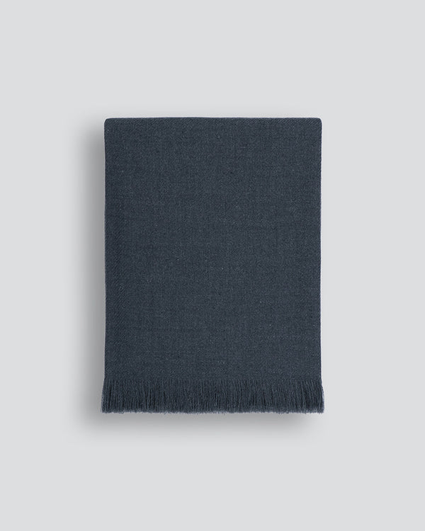 Altona Throw Add a pared-back accent to your space with the lightweight softness of Altona. Finely woven from a blend of wool and recycled polyester, the solid colour and delicate fringe edge makes this piece easy to style into most interior schemes. The