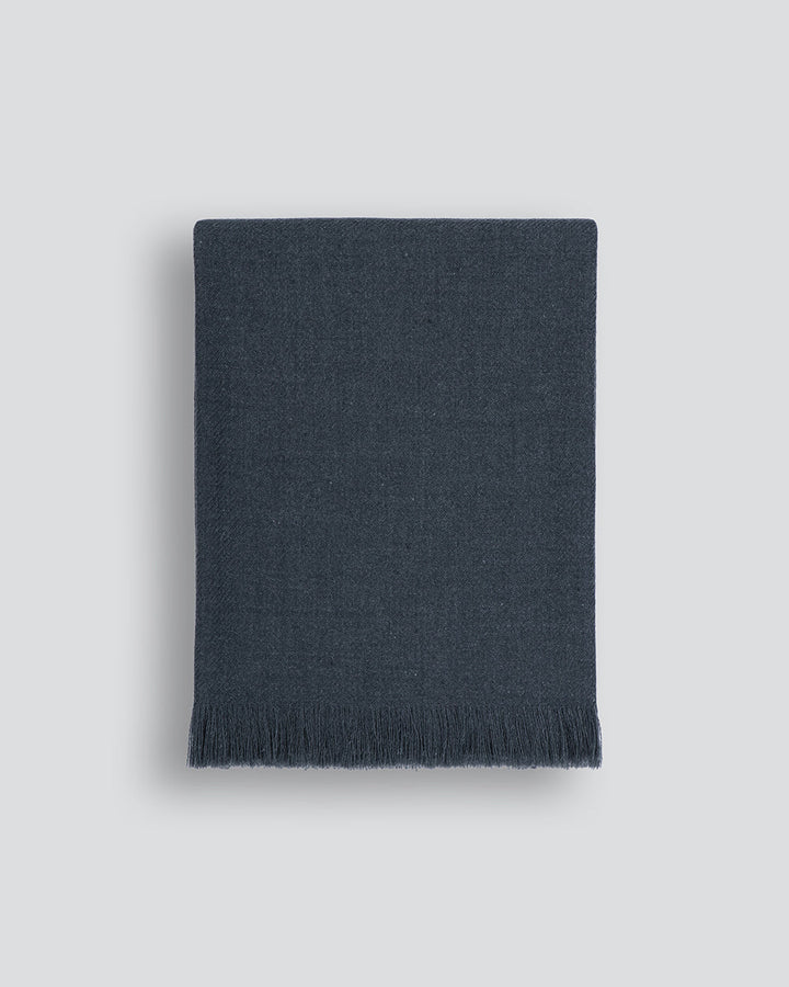 Altona Throw Add a pared-back accent to your space with the lightweight softness of Altona. Finely woven from a blend of wool and recycled polyester, the solid colour and delicate fringe edge makes this piece easy to style into most interior schemes. The