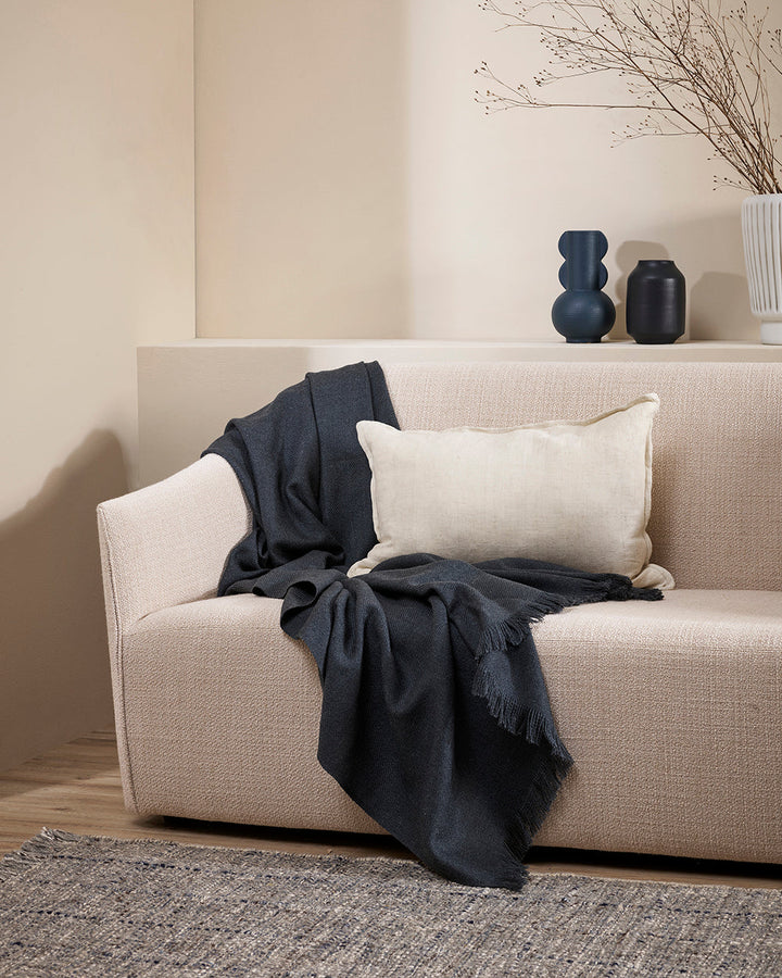 Altona Throw Add a pared-back accent to your space with the lightweight softness of Altona. Finely woven from a blend of wool and recycled polyester, the solid colour and delicate fringe edge makes this piece easy to style into most interior schemes. The