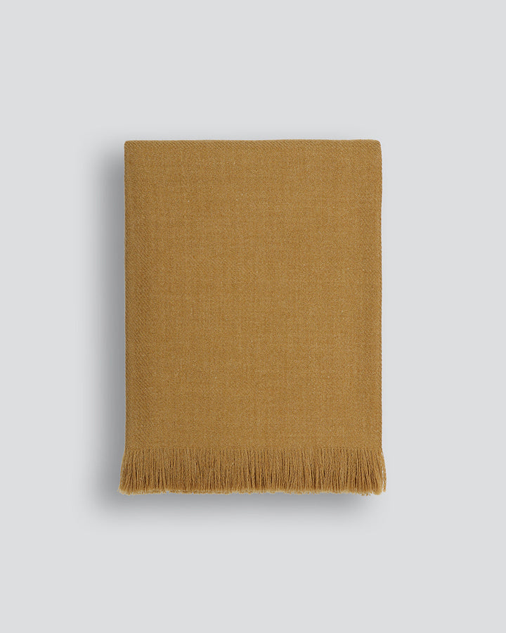 Altona Throw Add a pared-back accent to your space with the lightweight softness of Altona. Finely woven from a blend of wool and recycled polyester, the solid colour and delicate fringe edge makes this piece easy to style into most interior schemes. The