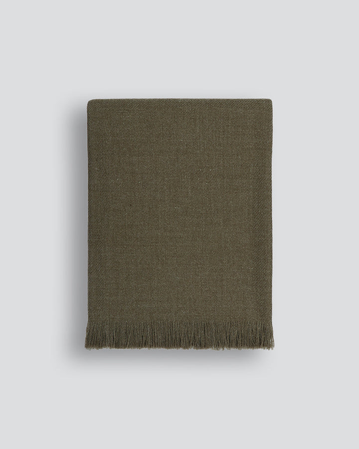 Altona Throw Add a pared-back accent to your space with the lightweight softness of Altona. Finely woven from a blend of wool and recycled polyester, the solid colour and delicate fringe edge makes this piece easy to style into most interior schemes. The