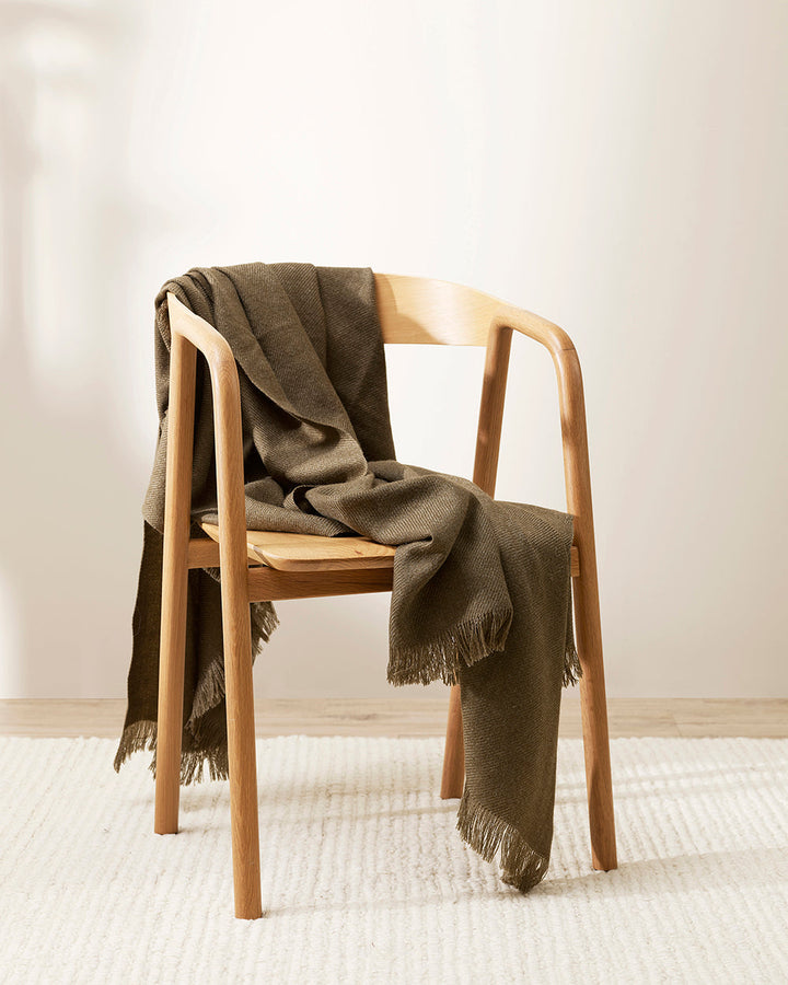 Altona Throw Add a pared-back accent to your space with the lightweight softness of Altona. Finely woven from a blend of wool and recycled polyester, the solid colour and delicate fringe edge makes this piece easy to style into most interior schemes. The