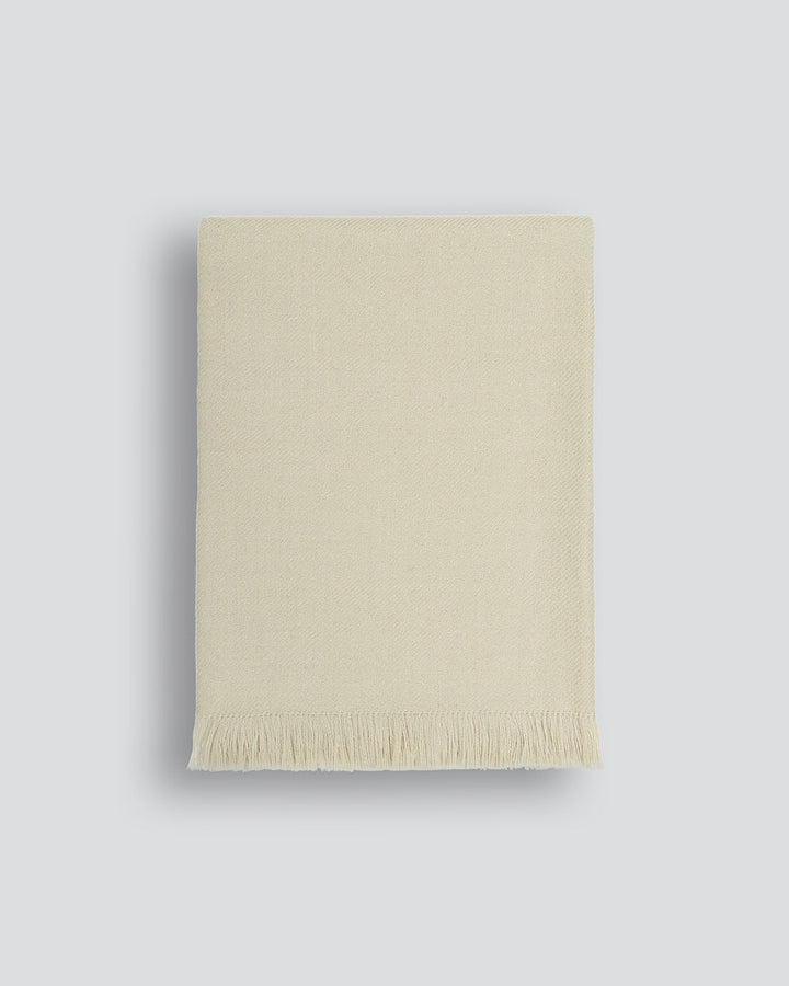 Altona Throw Add a pared-back accent to your space with the lightweight softness of Altona. Finely woven from a blend of wool and recycled polyester, the solid colour and delicate fringe edge makes this piece easy to style into most interior schemes. The