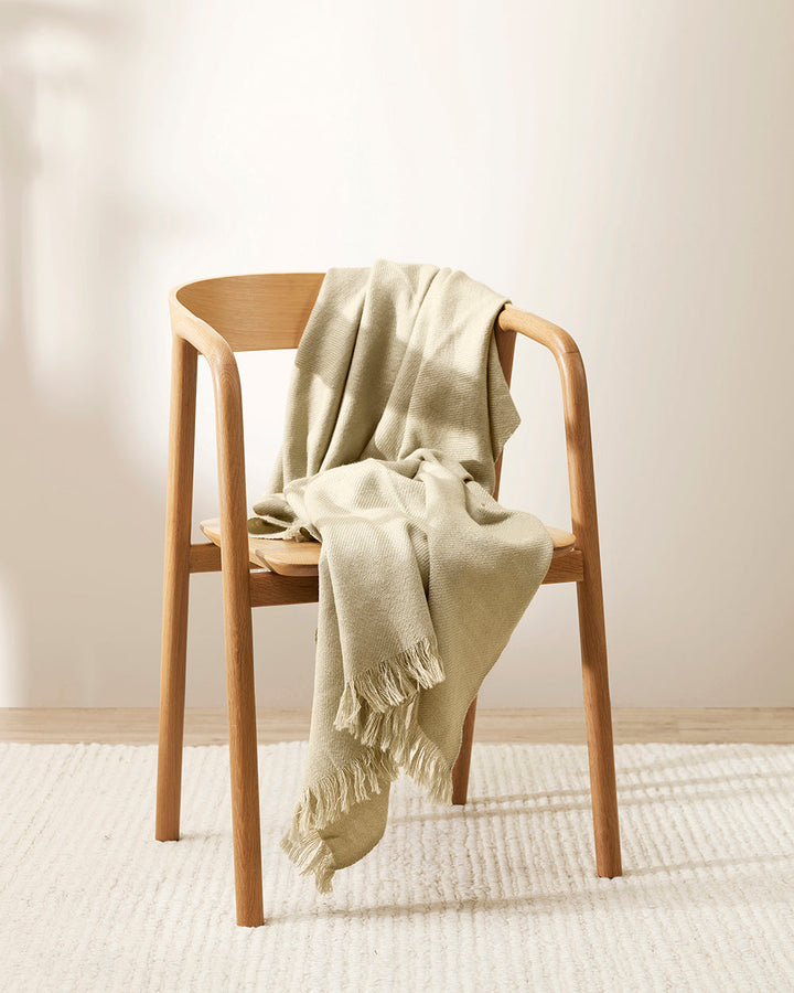 Altona Throw Add a pared-back accent to your space with the lightweight softness of Altona. Finely woven from a blend of wool and recycled polyester, the solid colour and delicate fringe edge makes this piece easy to style into most interior schemes. The