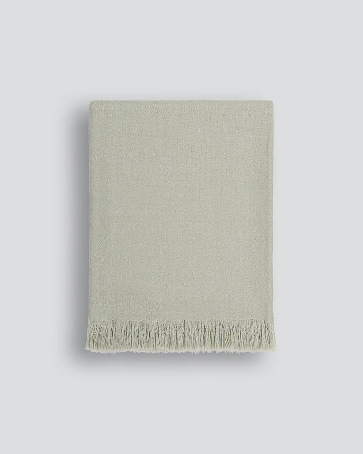 Altona Throw Add a pared-back accent to your space with the lightweight softness of Altona. Finely woven from a blend of wool and recycled polyester, the solid colour and delicate fringe edge makes this piece easy to style into most interior schemes. The