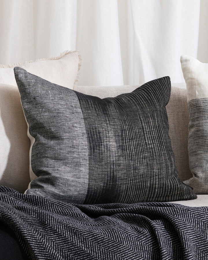 Anderson Cushion Embrace contemporary luxury with the artisan weave of our Anderson cushion. Crafted in a cool monochromatic palette in an off-set stripe, this double-sided design in 100% linen provides a simple, textural aesthetic for a modern living spa