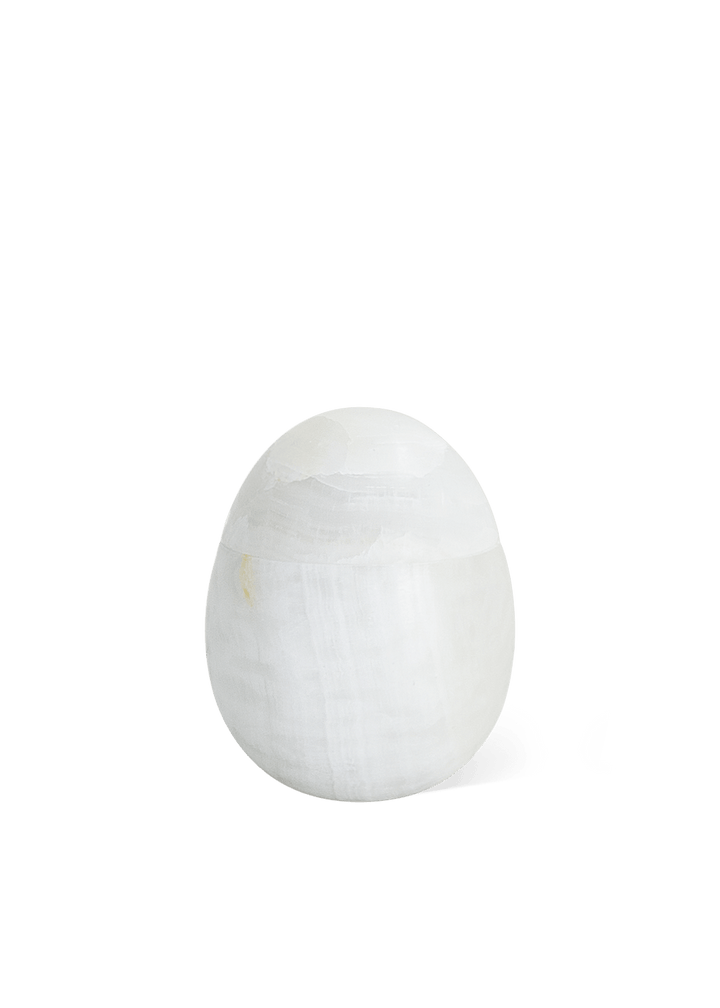 Eggshell Stone Storage Accessories Available at BEON | Crafted from exquisite white onyx with a matte finish, our Eggshell Stone Storage embodies minimalist elegance. Its egg-shaped design adds a touch of intrigue, making it perfect for table-top decor or