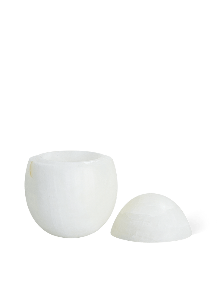 Eggshell Stone Storage Accessories Available at BEON | Crafted from exquisite white onyx with a matte finish, our Eggshell Stone Storage embodies minimalist elegance. Its egg-shaped design adds a touch of intrigue, making it perfect for table-top decor or