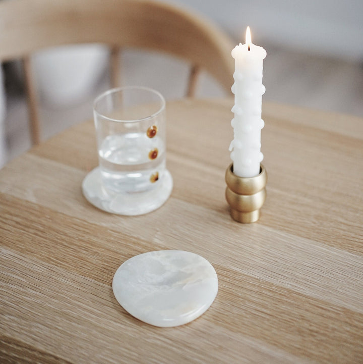 Stone Coaster Set - White Onyx Accessories Available at BEON | Experience nature's embrace with the irregular circular design of the Stone Coaster. Handcrafted with meticulous attention to detail, each coaster possesses its distinct character, making ever